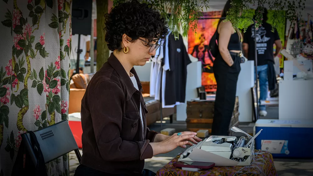 Poet at typewriter during street festival