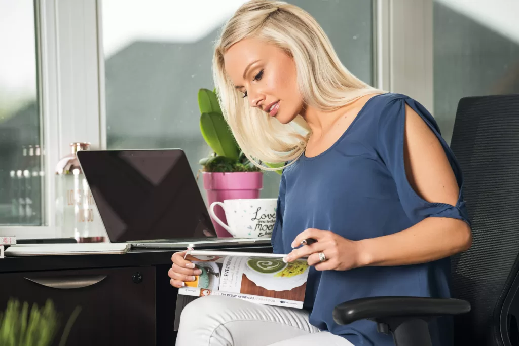 Kyla at her office desk with laptop and tea.