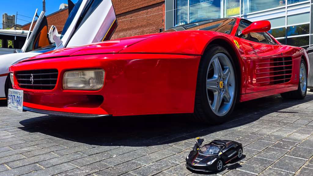 tunning red Ferrari Testarossa with iconic side strakes displaying Italian automotive artistry at the Guelph Exotic Car Show